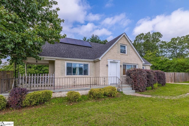 6913 White Horse Rd, Greenville, SC 29611 - view of front of home featuring roof with shingles, brick siding, and roof mounted solar panels