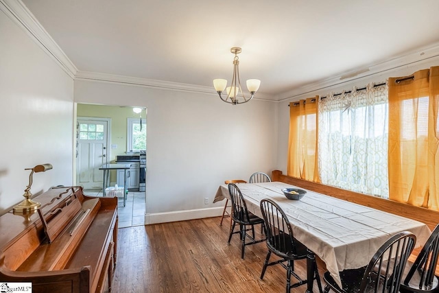 6913 White Horse Rd, Greenville, SC 29611 - dining area featuring ornamental molding, a chandelier, wood finished floors, and baseboards