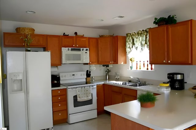 213 Kingscreek Dr, Greer, SC 29650 - kitchen with white appliances, a sink, light countertops, a peninsula, and brown cabinets