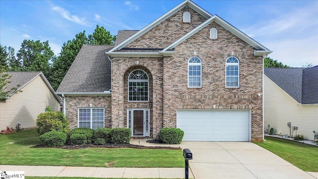 102 Eagle Pass Dr, Taylors, SC 29687 - traditional-style home with brick siding, an attached garage, concrete driveway, and a front yard