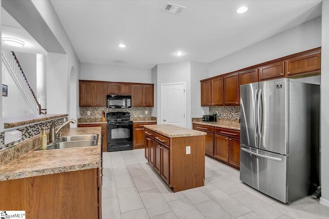 102 Eagle Pass Dr, Taylors, SC 29687 - kitchen featuring black appliances, a sink, decorative backsplash, a center island, and light countertops