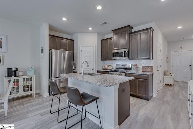 404 Hillrock Ct, Greenville, SC 29617 - kitchen with appliances with stainless steel finishes, a sink, light stone countertops, baseboards, and dark brown cabinets