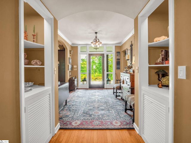 11 Hearthstone Ln, Landrum, SC 29356 - foyer entrance with crown molding, arched walkways, a chandelier, and wood finished floors