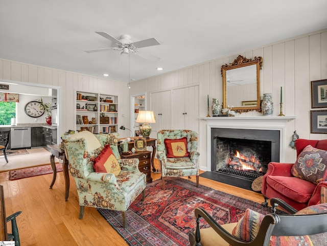 11 Hearthstone Ln, Landrum, SC 29356 - living room featuring wood finished floors, a warm lit fireplace, ceiling fan, wooden walls, and recessed lighting
