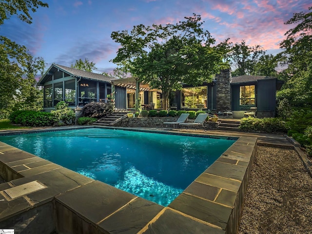 11 Hearthstone Ln, Landrum, SC 29356 - pool at dusk featuring an outdoor pool and a sunroom