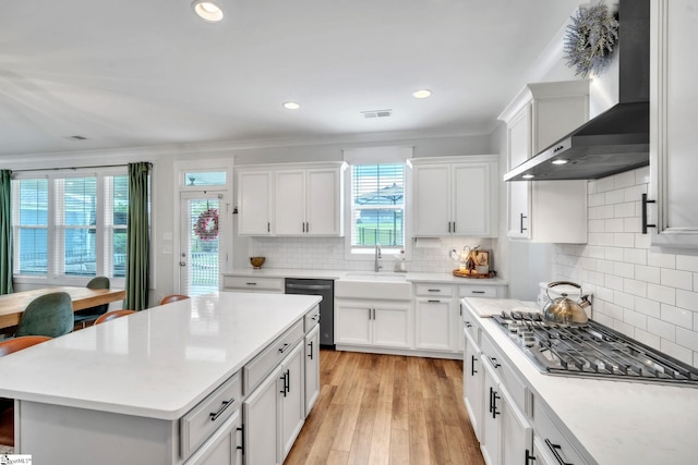 706 Torridon Ln, Simpsonville, SC 29681 - kitchen featuring wall chimney exhaust hood, appliances with stainless steel finishes, a sink, crown molding, and light countertops