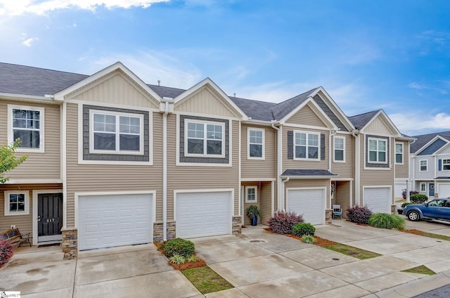 219 Button Willow St, Taylors, SC 29687 - view of property with stone siding, driveway, an attached garage, and board and batten siding