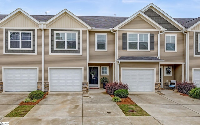 219 Button Willow St, Taylors, SC 29687 - townhome / multi-family property featuring stone siding, driveway, and board and batten siding