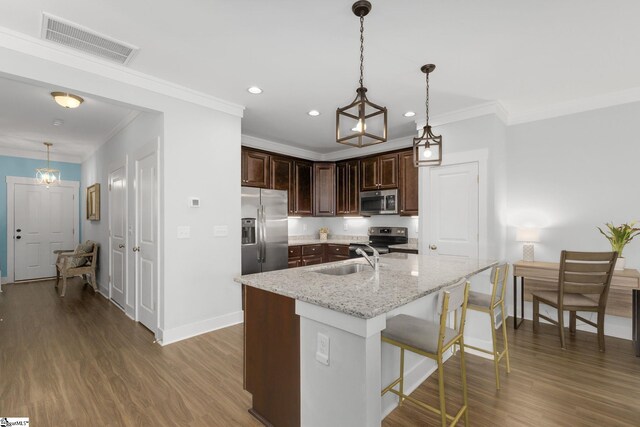 219 Button Willow St, Taylors, SC 29687 - kitchen with appliances with stainless steel finishes, a sink, baseboards, ornamental molding, and dark wood-style floors