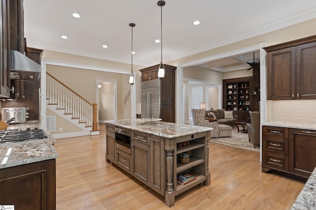 105 Hampton Grove Way, Greenville, SC 29617 - kitchen featuring appliances with stainless steel finishes, dark brown cabinets, ornamental molding, ceiling fan, and a center island