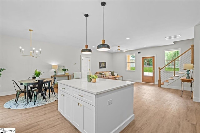 148 Duncan Chapel Rd, Greenville, SC 29617 - kitchen with light wood-style flooring, baseboards, white cabinets, a center island, and recessed lighting