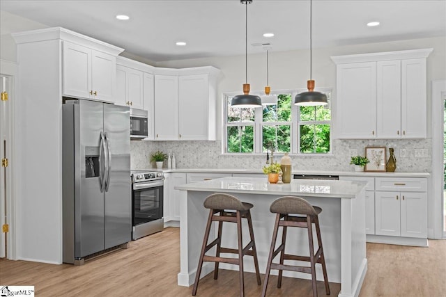148 Duncan Chapel Rd, Greenville, SC 29617 - kitchen featuring stainless steel appliances, light countertops, light wood-type flooring, white cabinets, and recessed lighting