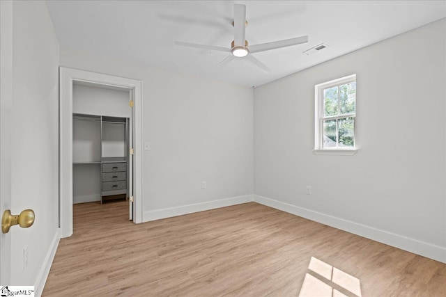 148 Duncan Chapel Rd, Greenville, SC 29617 - unfurnished bedroom featuring a walk in closet, baseboards, light wood-style floors, and ceiling fan