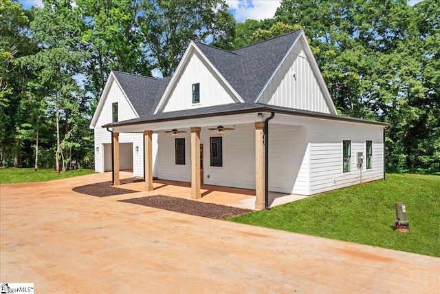 148 Duncan Chapel Rd, Greenville, SC 29617 - view of front of property featuring a ceiling fan, board and batten siding, a shingled roof, a front yard, and driveway