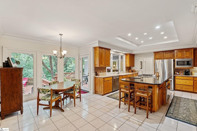 120 Thornblade Blvd, Greer, SC 29650 - kitchen with appliances with stainless steel finishes, healthy amount of natural light, a chandelier, a sink, and crown molding