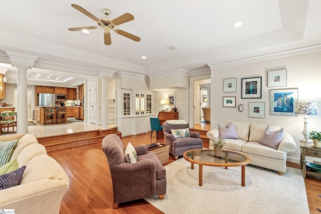 120 Thornblade Blvd, Greer, SC 29650 - living room with decorative columns, a raised ceiling, crown molding, ceiling fan, and light wood finished floors