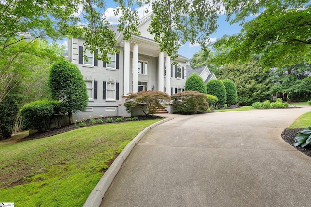 120 Thornblade Blvd, Greer, SC 29650 - greek revival house featuring a front yard, stucco siding, and concrete driveway
