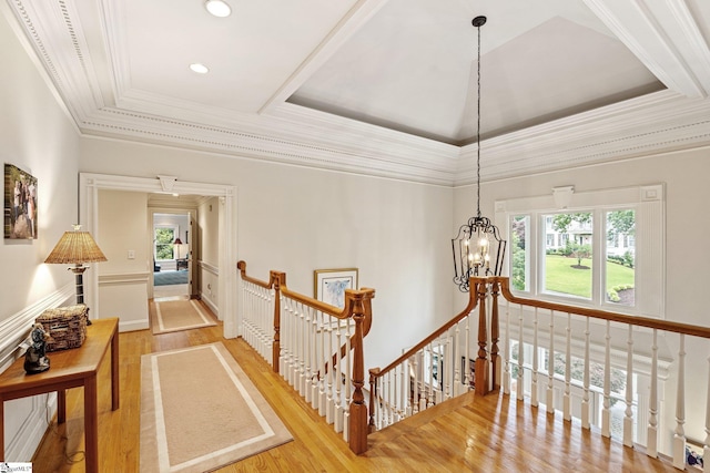 120 Thornblade Blvd, Greer, SC 29650 - hall with an upstairs landing, a raised ceiling, a chandelier, light wood-style floors, and crown molding