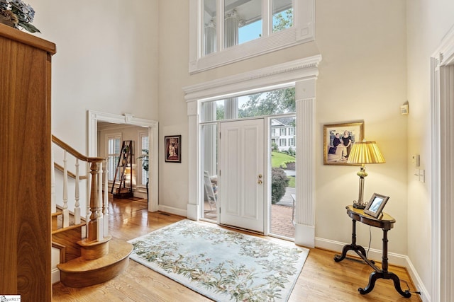 120 Thornblade Blvd, Greer, SC 29650 - foyer featuring a high ceiling, stairway, light wood-type flooring, and baseboards