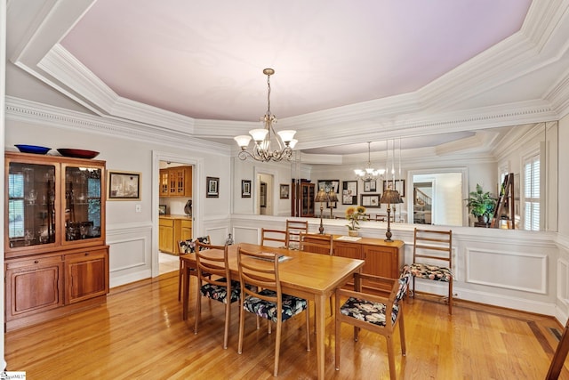 120 Thornblade Blvd, Greer, SC 29650 - dining room featuring a chandelier, light wood-style floors, a decorative wall, crown molding, and wainscoting