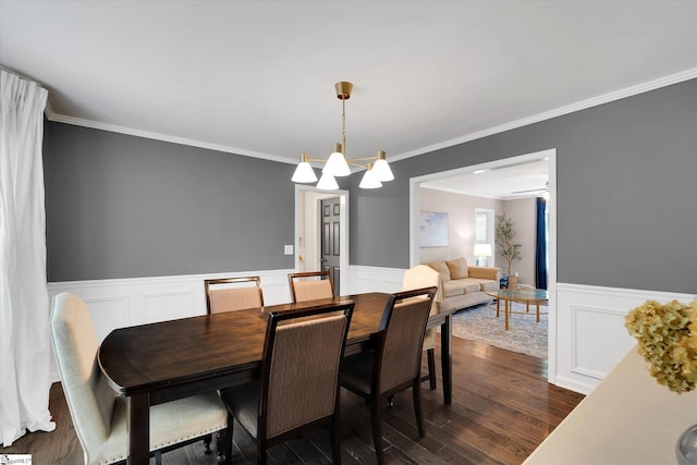 121 Legrae Ln, Taylors, SC 29687 - dining space featuring a wainscoted wall, crown molding, dark wood-type flooring, a chandelier, and a decorative wall