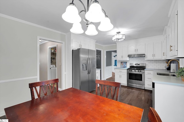 121 Legrae Ln, Taylors, SC 29687 - kitchen featuring stainless steel appliances, a sink, under cabinet range hood, a chandelier, and dark wood-type flooring
