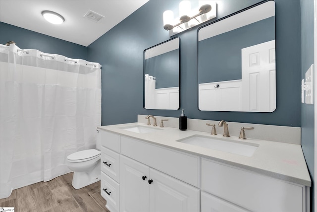 121 Legrae Ln, Taylors, SC 29687 - full bath featuring wood finished floors, toilet, and double vanity