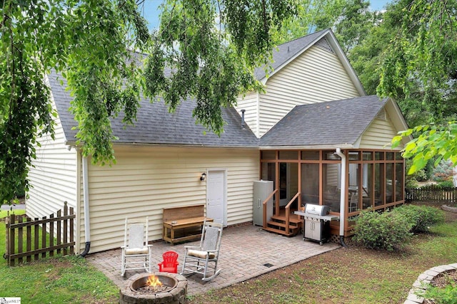 121 Legrae Ln, Taylors, SC 29687 - back of property with a fire pit, a sunroom, a shingled roof, and a patio
