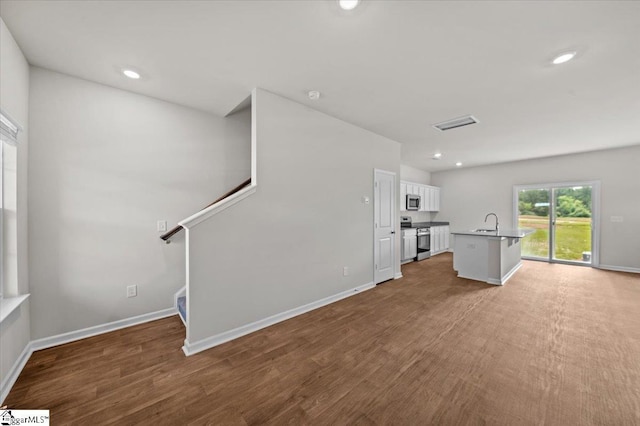 215 Islay Way, Anderson, SC 29621 - unfurnished living room featuring recessed lighting, wood finished floors, and stairway