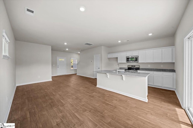 215 Islay Way, Anderson, SC 29621 - kitchen with stainless steel appliances, white cabinets, light wood-style floors, and recessed lighting