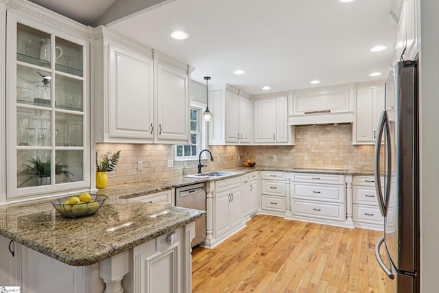 310 Wofford Rd, Pauline, SC 29374 - kitchen with appliances with stainless steel finishes, a peninsula, a sink, exhaust hood, and white cabinetry