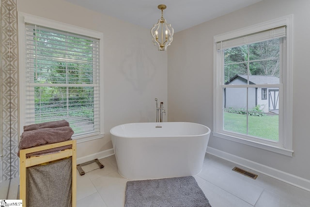 9 Mountain Brook Trl, Greenville, SC 29609 - bathroom with baseboards, a soaking tub, tile patterned floors, and a chandelier