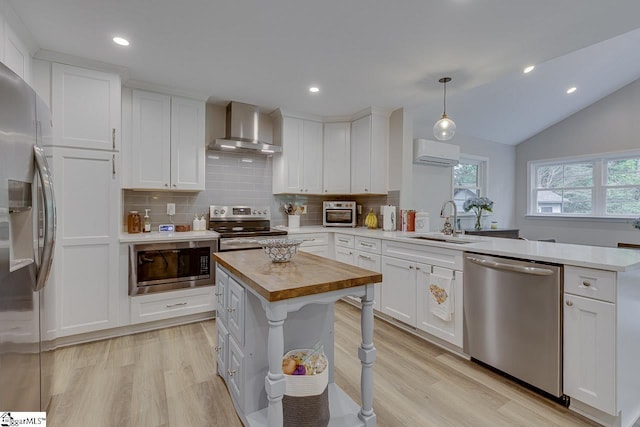 9 Mountain Brook Trl, Greenville, SC 29609 - kitchen with stainless steel appliances, wall chimney exhaust hood, a sink, butcher block countertops, and a peninsula
