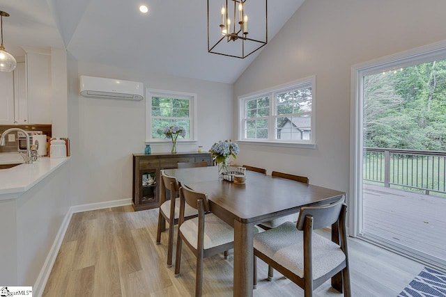 9 Mountain Brook Trl, Greenville, SC 29609 - dining space featuring an AC wall unit, light wood-style floors, high vaulted ceiling, baseboards, and a chandelier