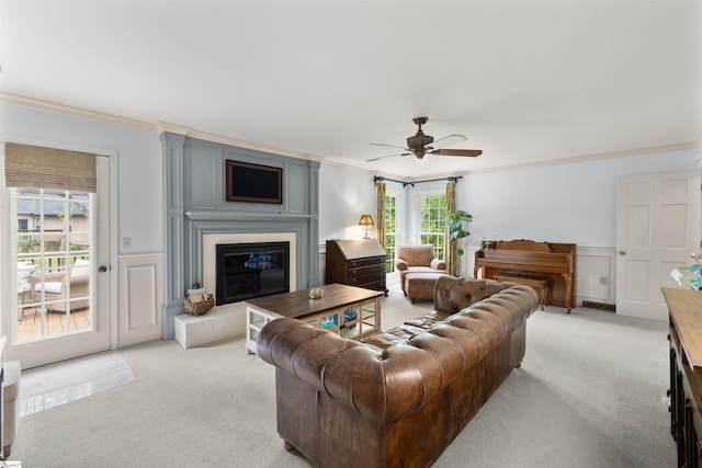 109 Appomattox Dr, Simpsonville, SC 29681 - living area featuring ornamental molding, light colored carpet, ceiling fan, a glass covered fireplace, and a wainscoted wall