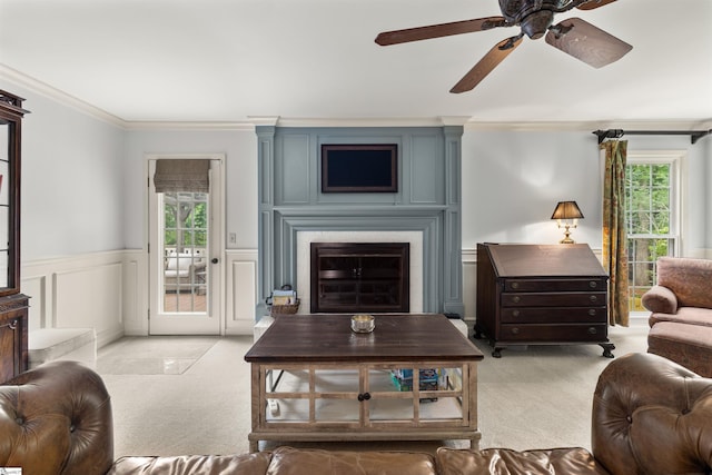 109 Appomattox Dr, Simpsonville, SC 29681 - living area featuring light colored carpet, ceiling fan, ornamental molding, a wainscoted wall, and a glass covered fireplace