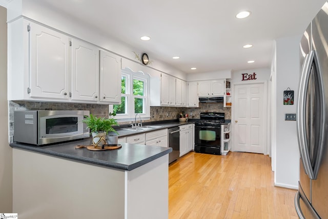 101 Long View Ln, Pickens, SC 29671 - kitchen featuring appliances with stainless steel finishes, a sink, under cabinet range hood, dark countertops, and white cabinets