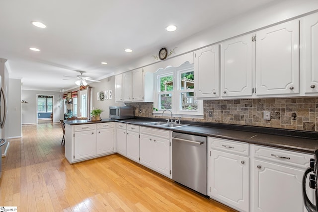 101 Long View Ln, Pickens, SC 29671 - kitchen featuring stainless steel appliances, a sink, a peninsula, dark countertops, and recessed lighting