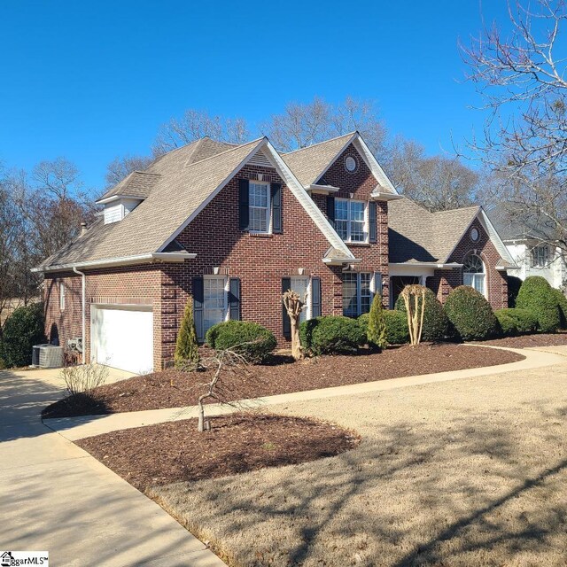 424 Grand Oak Way, Moore, SC 29369 - view of front facade featuring brick siding, concrete driveway, a garage, roof with shingles, and central AC