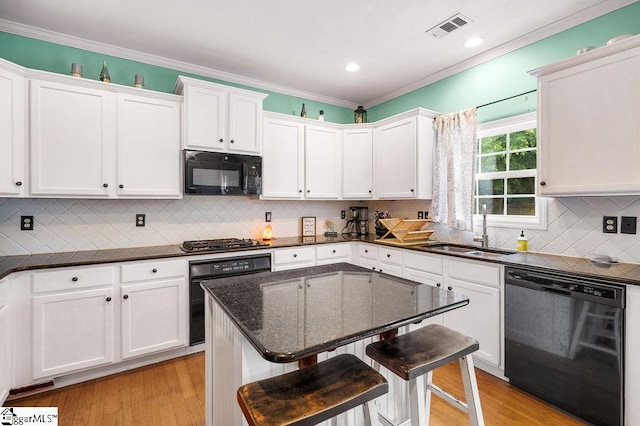 9 Peninsula Ct, Simpsonville, SC 29681 - kitchen featuring black appliances, a sink, white cabinets, a kitchen breakfast bar, and ornamental molding