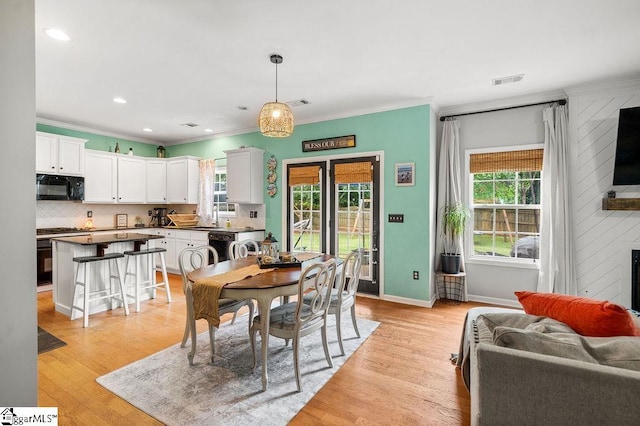 9 Peninsula Ct, Simpsonville, SC 29681 - dining space with crown molding, healthy amount of natural light, baseboards, light wood-style flooring, and a fireplace