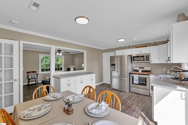 12 Ridgeline Dr, Liberty, SC 29657 - kitchen with appliances with stainless steel finishes, crown molding, a sink, light countertops, and white cabinetry