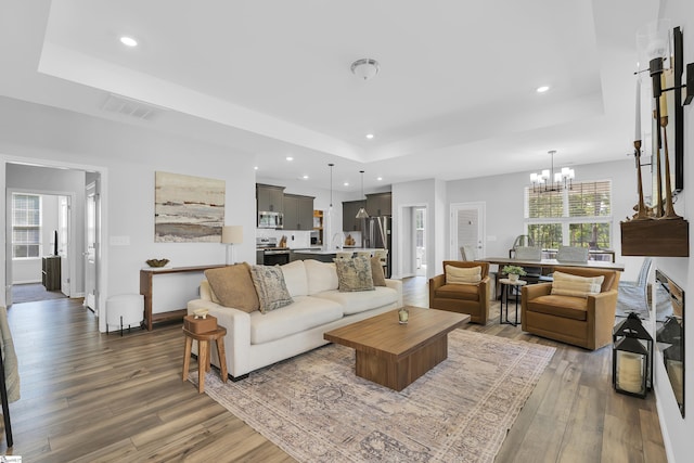 4250 Winding Ridge Ln, Boiling Springs, SC 29316 - living room featuring a raised ceiling, wood finished floors, a chandelier, recessed lighting, and baseboards