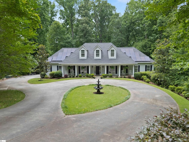 119 Oak Crest Cir, Seneca, SC 29672 - new england style home with curved driveway, a porch, roof mounted solar panels, and a front lawn