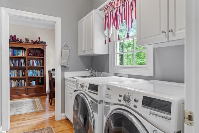 119 Oak Crest Cir, Seneca, SC 29672 - laundry room with washer and dryer, cabinet space, light wood-style flooring, and crown molding