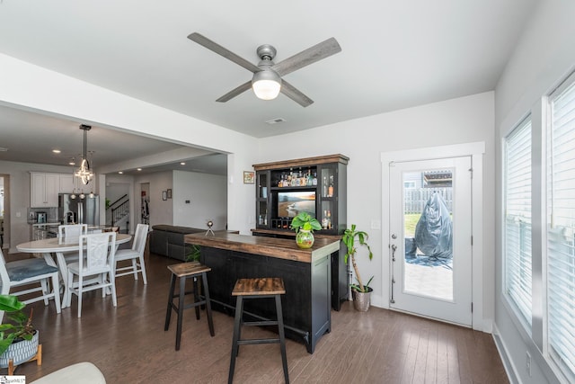 116 Quiet Creek Ct, Simpsonville, SC 29681 - kitchen with stainless steel fridge, a kitchen island with sink, butcher block counters, a breakfast bar area, and dark wood-style floors