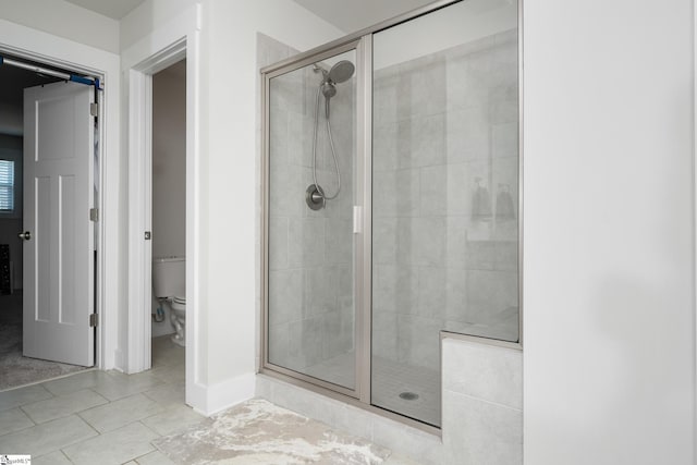 116 Quiet Creek Ct, Simpsonville, SC 29681 - bathroom featuring a stall shower, toilet, tile patterned flooring, and baseboards