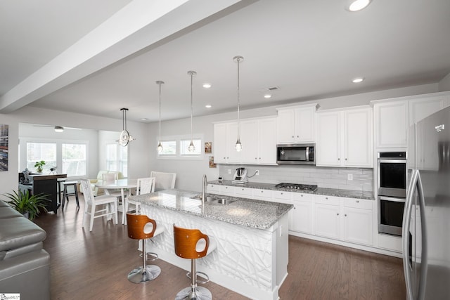 116 Quiet Creek Ct, Simpsonville, SC 29681 - kitchen featuring appliances with stainless steel finishes, plenty of natural light, light stone countertops, backsplash, and recessed lighting