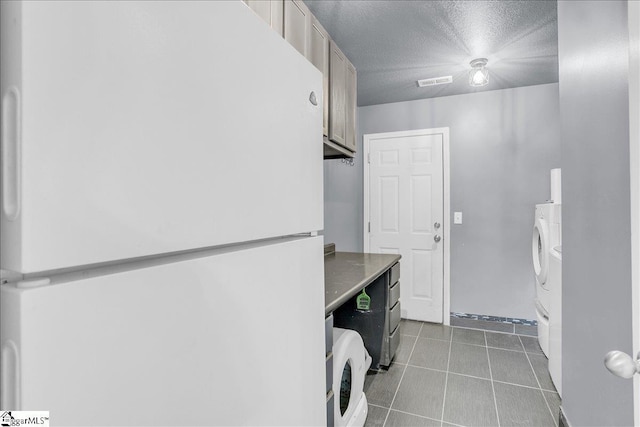 251 Heatherbrook Dr, Lyman, SC 29365 - laundry area with tile patterned flooring, a textured ceiling, cabinet space, and washer / clothes dryer