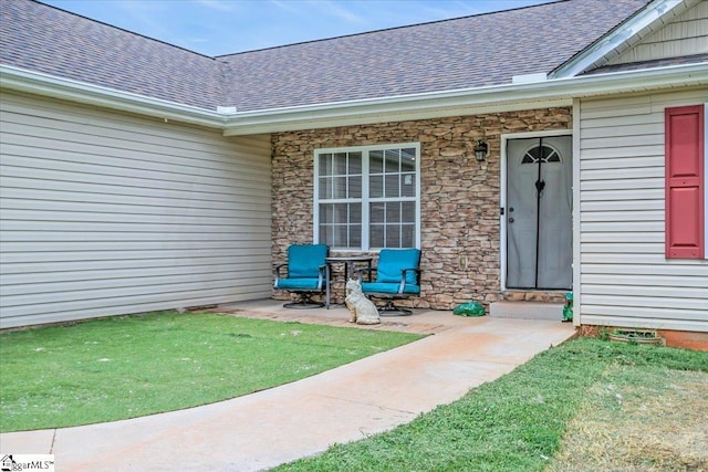 251 Heatherbrook Dr, Lyman, SC 29365 - view of exterior entry with a shingled roof, a lawn, and stone siding